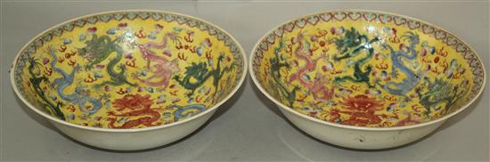 A pair of Chinese enamelled porcelain nine dragon bowls, Republic period, 21cm